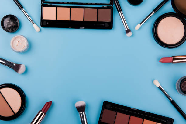 istock Cosmetic palette and face shadow with brushes lies on a blue background 1225863283