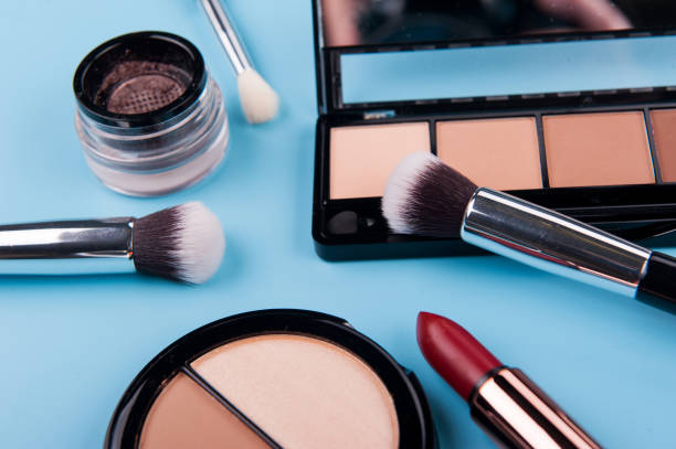 istock Cosmetic palette and face shadow with brushes lies on a blue background 1225863323