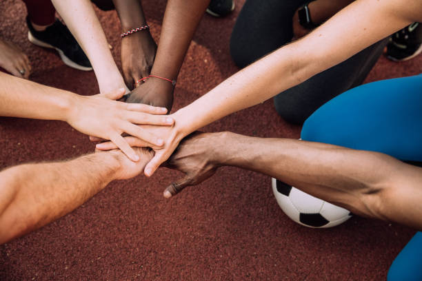istock Group of friends stacking hands 1225863360