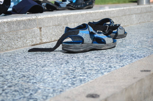istock Men's sandals were left on the street. 1225864802