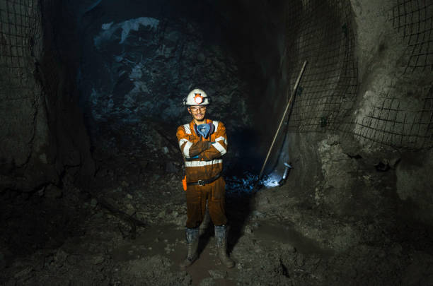 istock Miner in the mine. Well-uniformed miner inside mine raising thumb 1225866173