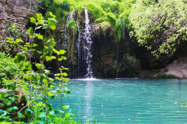 istock Waterfall that flows into a blue lake with clear water 1225867035