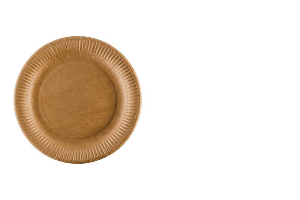 istock Eco-friendly natural plate with empty space. Disposable ecological utensils on white background. Sustainability of planet. Closeup isolated cardboard plate made of fiber of bamboo and bagasse. 1225867408