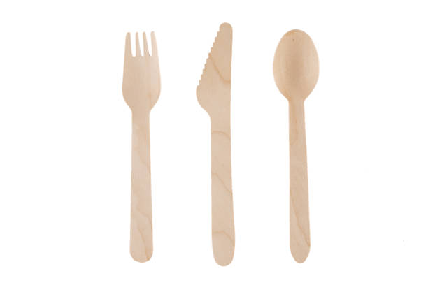 istock Eco-friendly natural spoon, knife, fork. Disposable ecological utensils on white background. Sustainability of planet. Closeup cutlery cardboard plate made of fiber of bamboo and bagasse. 1225867418