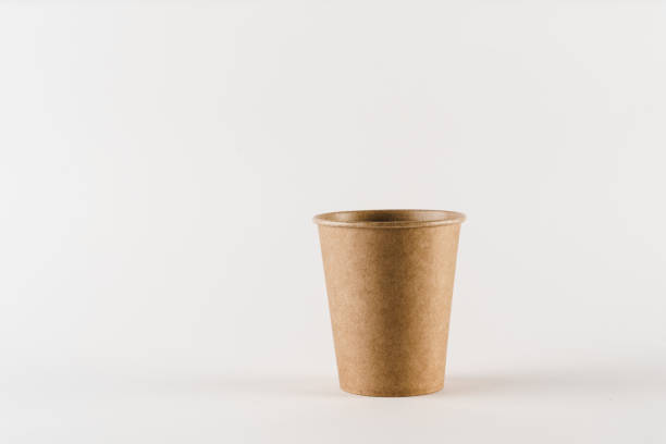 istock Eco-friendly natural coffee cup with empty space. Disposable ecological utensils on white background. Sustainability of planet. Cardboard glass made of fiber of bamboo and bagasse. 1225867439