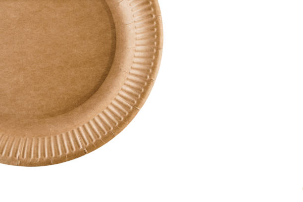 istock Eco-friendly natural plate with empty space. Disposable ecological utensils on white background. Sustainability of planet. Closeup isolated cardboard plate made of fiber of bamboo and bagasse. 1225867448