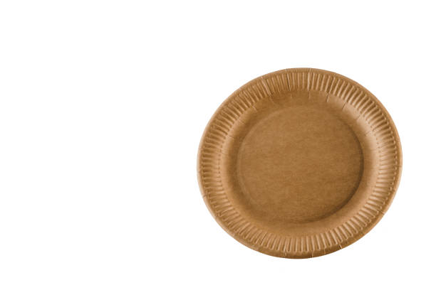 istock Eco-friendly natural plate with empty space. Disposable ecological utensils on white background. Sustainability of planet. Closeup isolated cardboard plate made of fiber of bamboo and bagasse. 1225867449