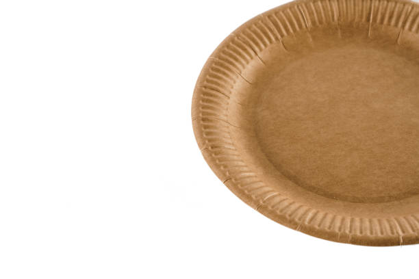istock Eco-friendly natural plate with empty space. Disposable ecological utensils on white background. Sustainability of planet. Closeup isolated cardboard plate made of fiber of bamboo and bagasse. 1225867470