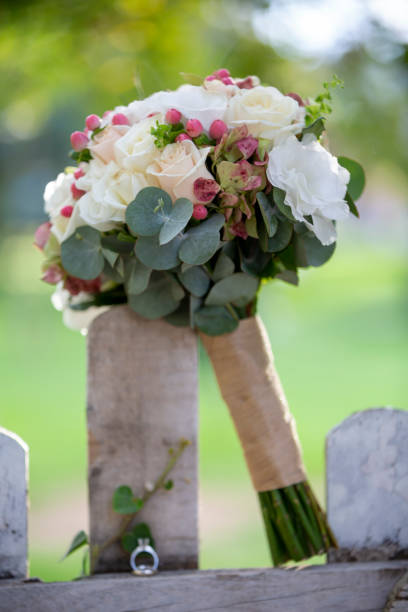 istock holding flowers in park 1225868264
