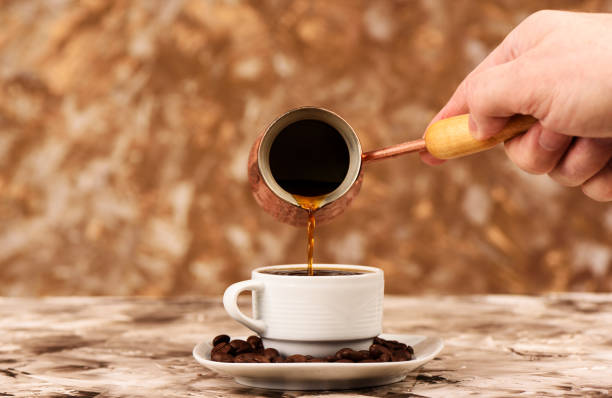 istock Pouring black coffee from cezve to a cup. 1225868407