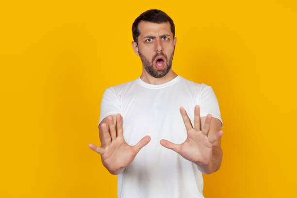 istock Frightened man stretched out his hands in front with a stop gesture 1225869358
