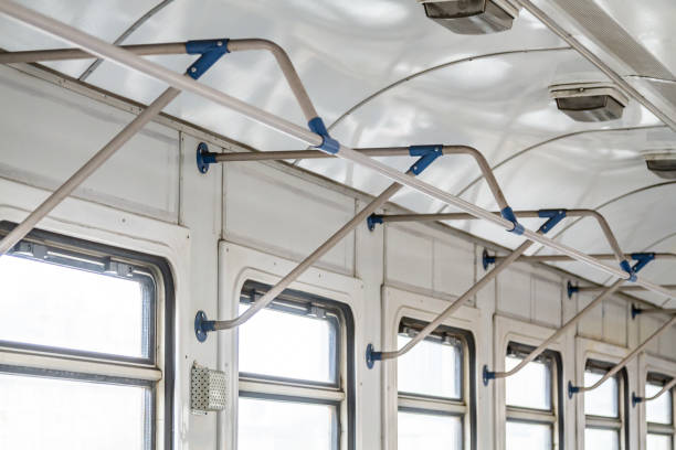 istock Metal handrails in an empty electric train in the afternoon on a light background. Horizontal orientation 1225871255