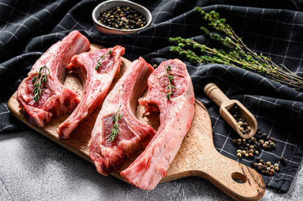 istock Raw fresh lamb ribs and spicy herbs. White background. Top view 1225871321