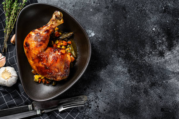 istock Grilled chicken legs with spices and garlic. Black background. Top view. Copy space 1225871358