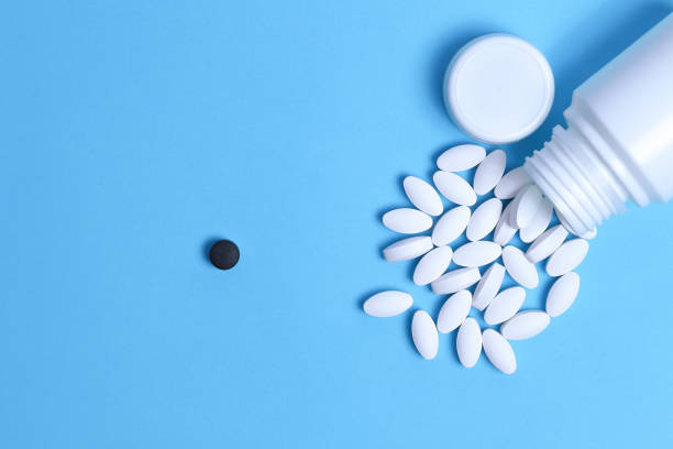 istock Different pills. Medical and different concept of light blue paper background. Copy space. 1225872467