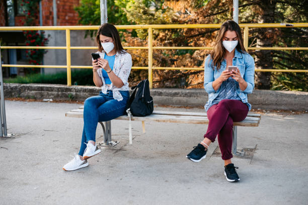 istock Women having social distancing at a bus stop 1225872568