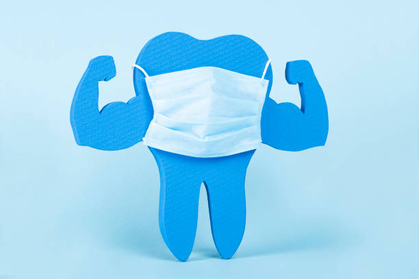 Blue and Very Strong Muscle Healthy Tooth with mask Blue and Very Strong Muscle Healthy Tooth with mask isolated on blue background snow white and the seven dwarfs photos stock pictures, royalty-free photos & images