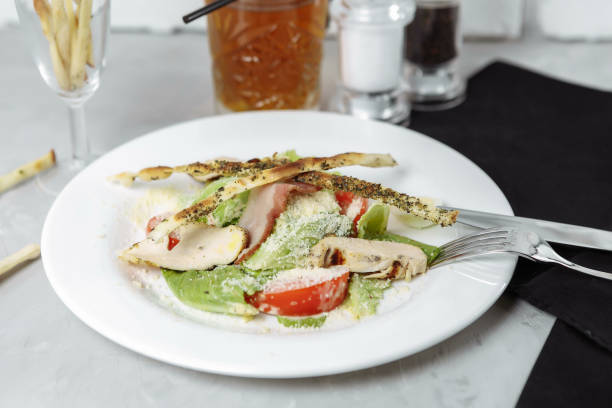 istock Fresh caesar salad with chicken breast and tomatoes 1225873467