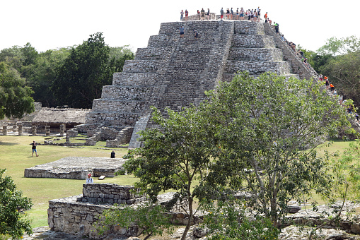 Mayapan, Yucatan, Mexico - Jan. 28, 2020:  Visitors exlore the  Temple of Kukulcan pyramid at the Mayan ruins at Mayapan, 35 miles southeast of Merida.  Mayapan was the Mayan capital of the Yucatan peninsula from approximately 1200 A.D. to 1400 A.D.