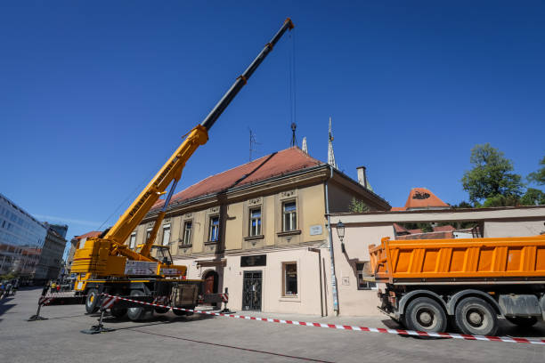Workers with cranes fixing the roofs after earthquake Zagreb, Croatia - April 16, 2020 : Workers with cranes fixing the roofs that was damaged by the earthquake of 5.5 on the Richter scale one month ago. zagreb earthquake stock pictures, royalty-free photos & images