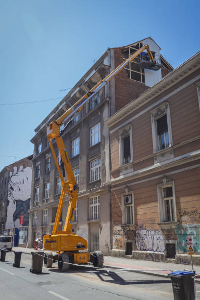 Workers with cranes fixing the roofs after earthquake Zagreb, Croatia - April 16, 2020 : Workers with cranes fixing the roofs that was damaged by the earthquake of 5.5 on the Richter scale one month ago. zagreb earthquake stock pictures, royalty-free photos & images