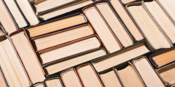 istock Open book, hardback books on wooden table. Back to school. Copy space. 1225876617