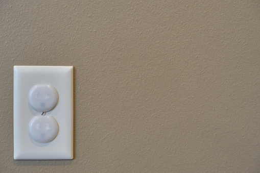 Typical outlet cover used in residential buildings to prevent a child from inserting objects