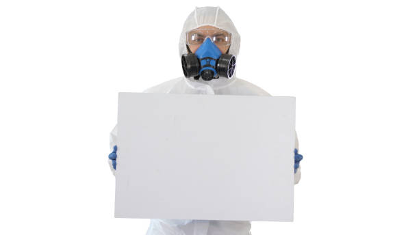 istock Lab scientist in safety suit holding empty white board on white background 1225877978
