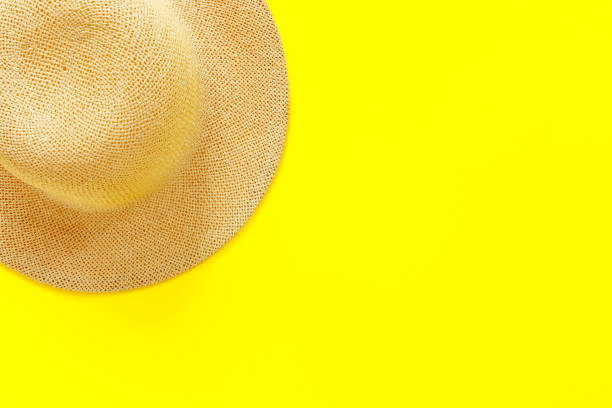 istock Fashionable straw hat on yellow paper background. 1225879206
