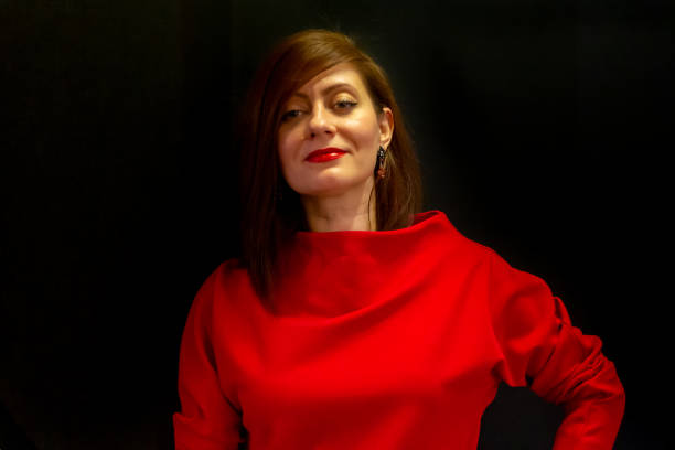 istock Woman in red on black background 1225879519