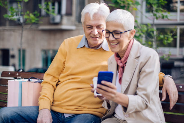 istock Senior couple enjoying together sitting on a park bench 1225882012