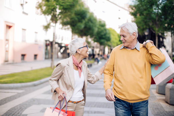 istock Old couple walking around town, shopping 1225882018