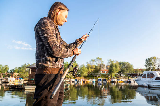 istock Fisherman setting fishing rod at the river bank 1225882995