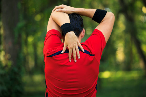 istock Young man stretching arm and shoulder outdoors 1225883251