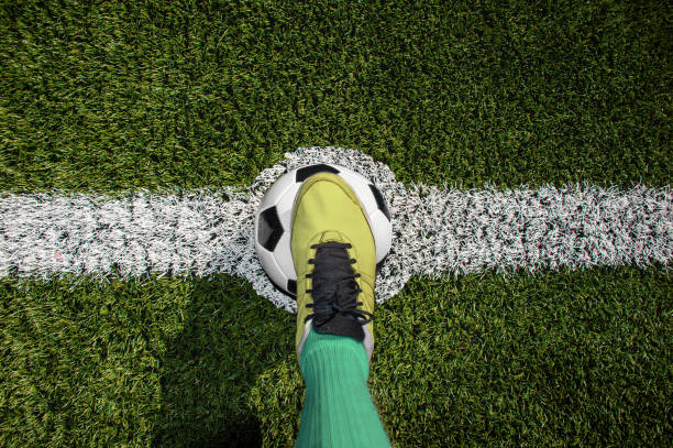 soccer kick start Top view of a soccer player standing on the center of soccer field football boot stock pictures, royalty-free photos & images