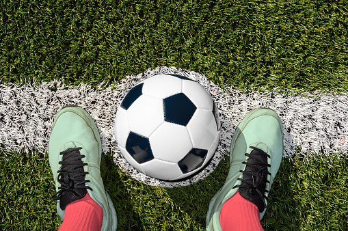 Shot of a soccer player standing on the field with ball on the center of soccer field