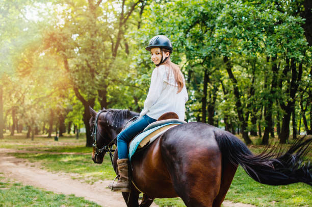 girl enjoying easy horse ride in woods - serbia horse nature landscape imagens e fotografias de stock