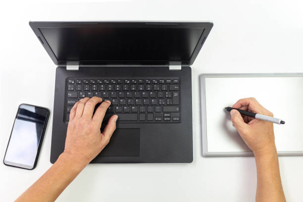istock Hands working on a black laptop and graphics tablet 1225886101