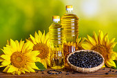 Rural still-life - sunflower oil in bottles with flowers of sunflower