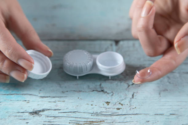 istock woman hand optical lenses 1225887707