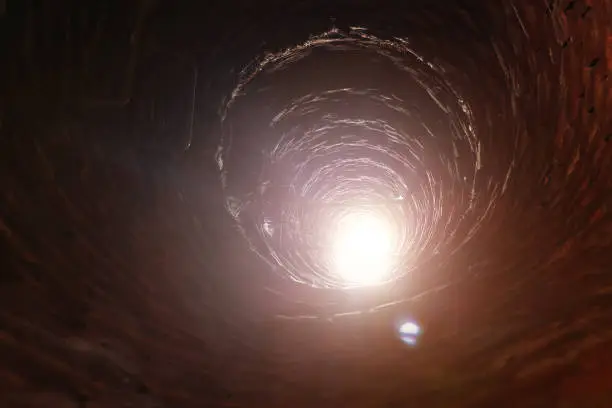 Photo of Inside old red brick tube with ladder