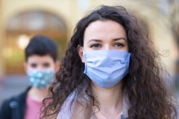 istock People wearing masks during COVID-19 outbreak 1225892037