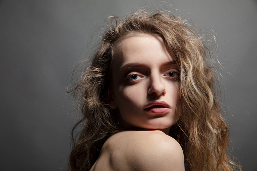 Beautiful young woman with curly hair