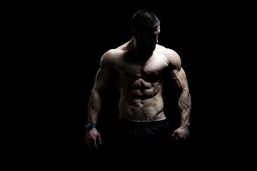 Young Bodybuilder Flexing Muscles - Isolate on Black Blackground - Copy Space