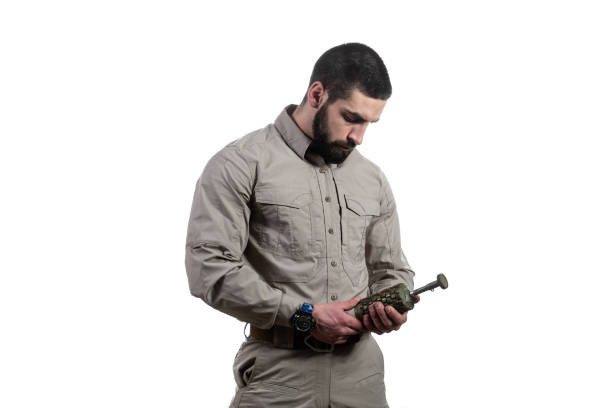 istock Young Man Holding a Bomb on White Background 1225892646