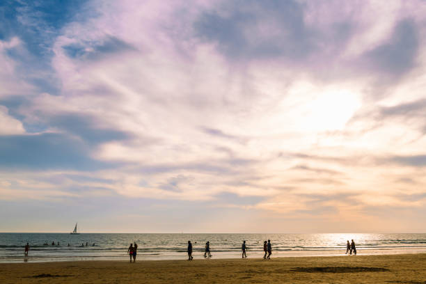 istock people walking on the beach in summer at sunset 1225893297