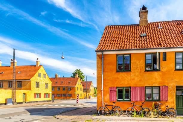 Old yellow houses of Nyboder district with bicycles. Old Medieval district in Copenhagen, Denmark.
