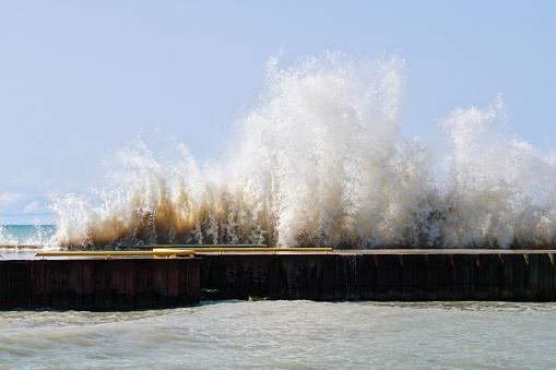 Waves crashing on a pier
