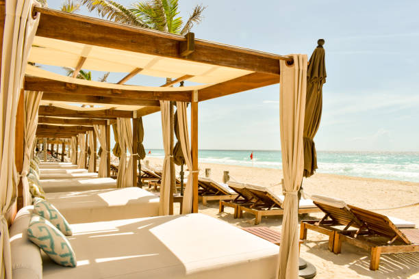 Luxury Beach Beds for relaxation on the beach in Cancun, Mexico Row of cabanas on a tropical beach in Mexico beach hut stock pictures, royalty-free photos & images