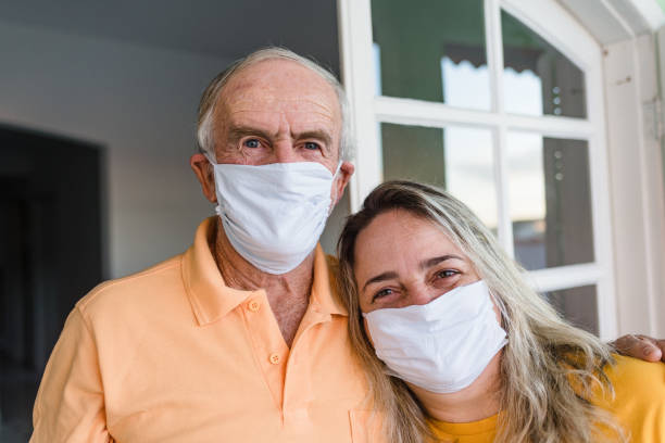 istock Dad and daughter holding each other using face mask 1225899152